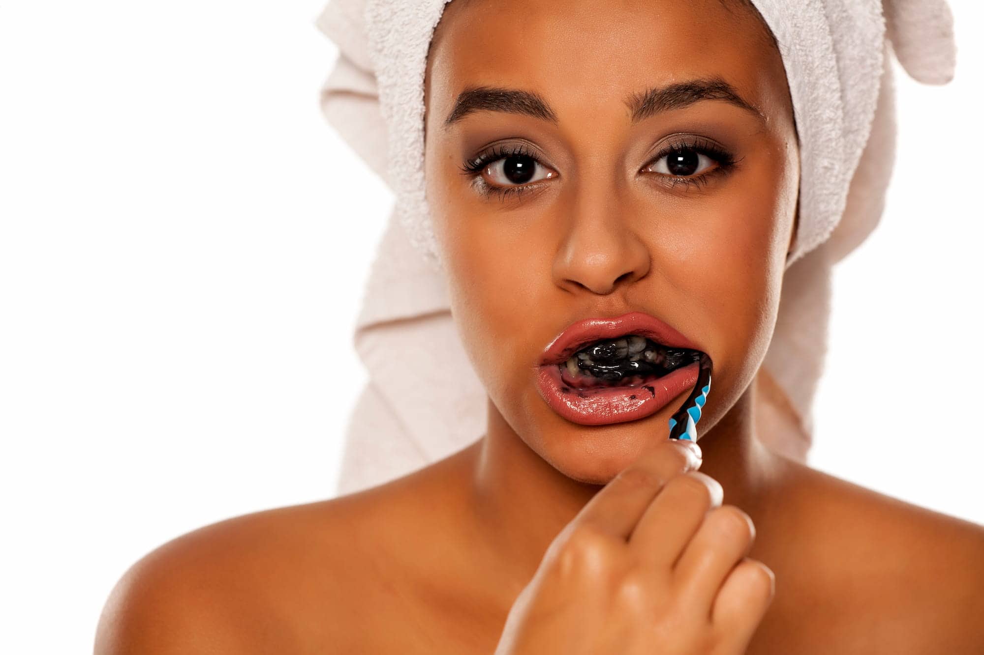 Woman wondering &ldquo;Is charcoal toothpaste bad for your teeth?