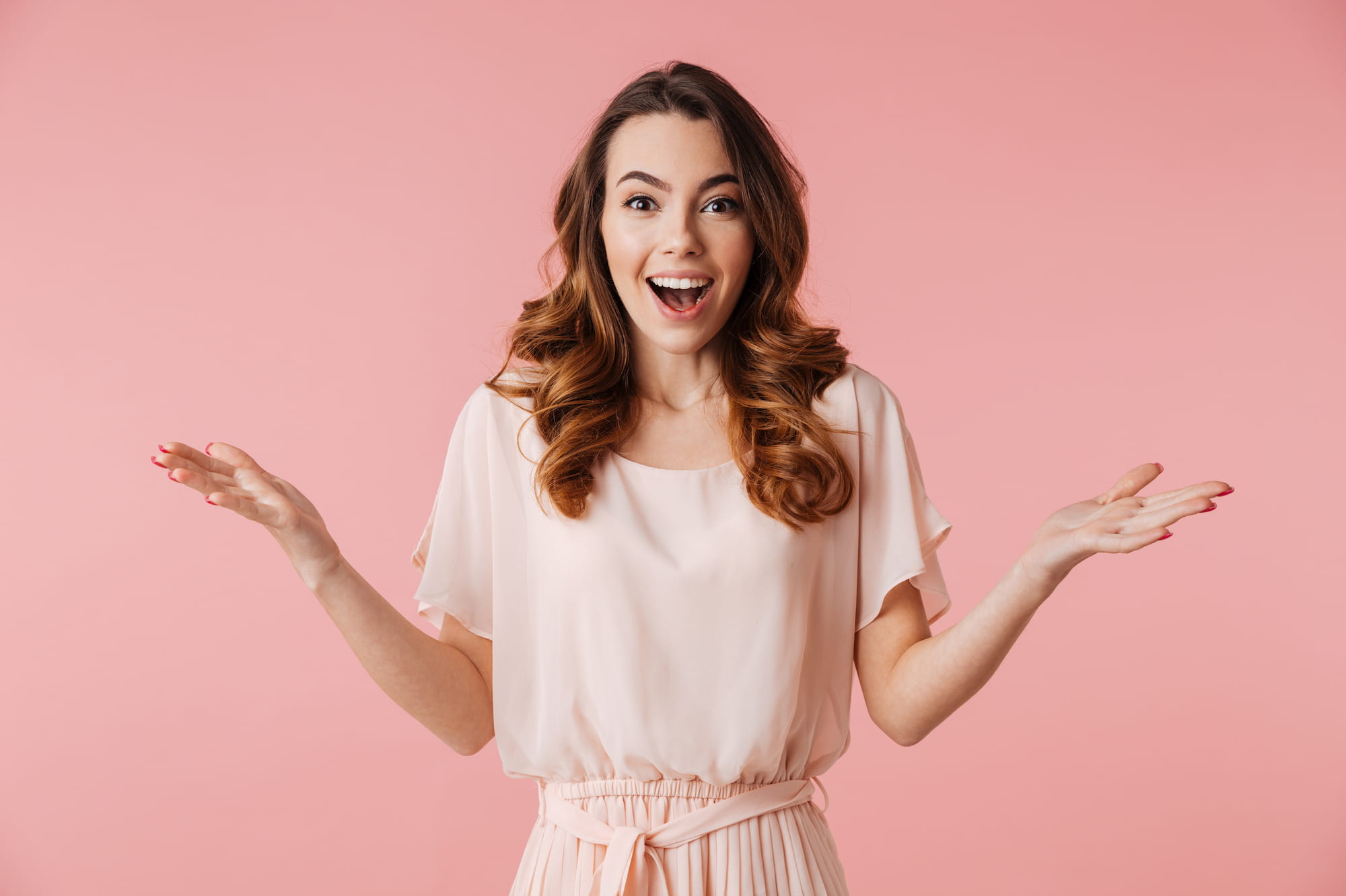A woman shows off her gorgeous smile after receiving treatment from adult braces.