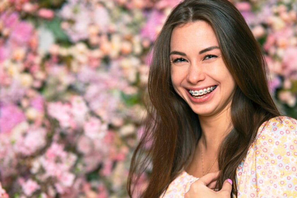 A woman with braces shows off her gorgeous smile.
