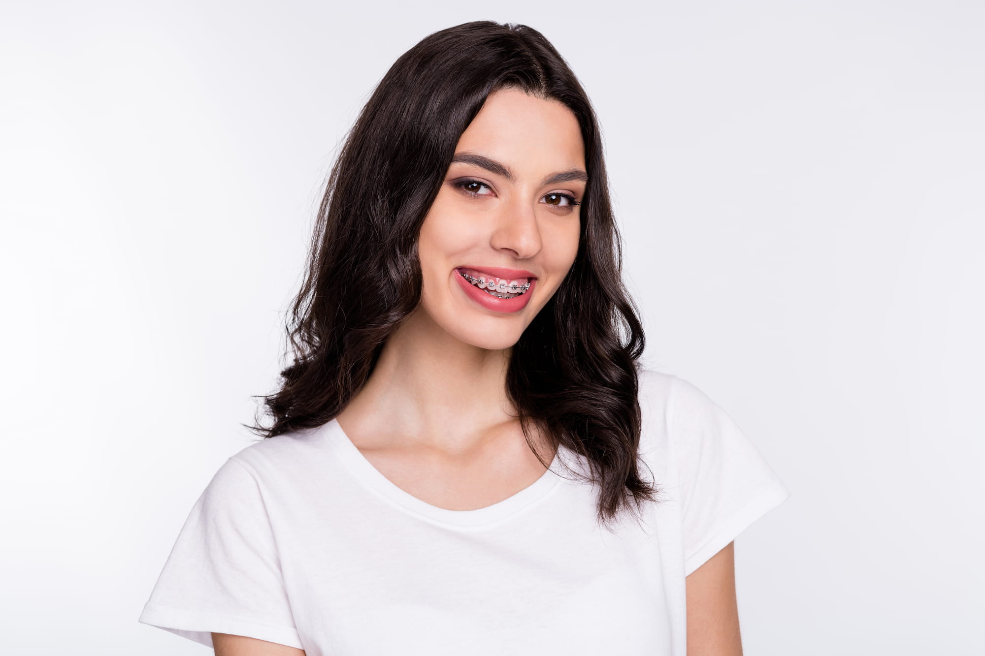 A young woman with braces shows off her soon to be dazzling smile.